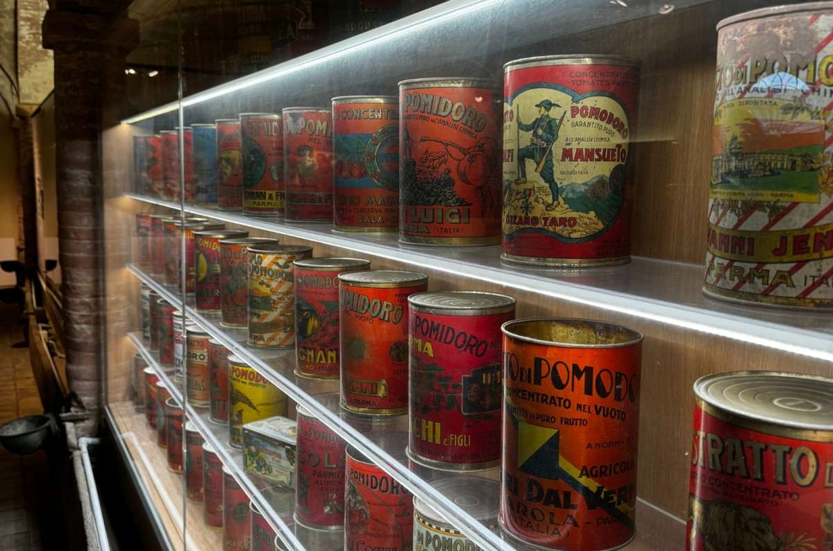 A display case filled with vintage Italian tomato cans in a museum Parma, Italy, photo by Next Level of Travel