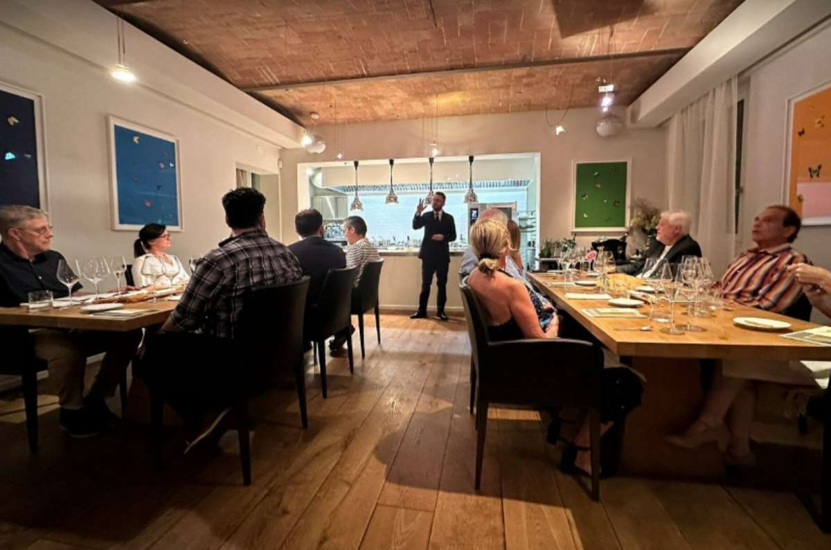 Diners seated at elegant wooden tables inside Osteria Francescana