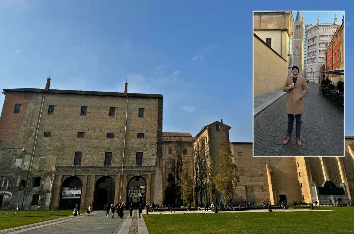 The central square of Parma, Italy, featuring Palazzo della Pilotta and a tourist in front of the Cathedral and Baptistery, photo by Next Level of Travel