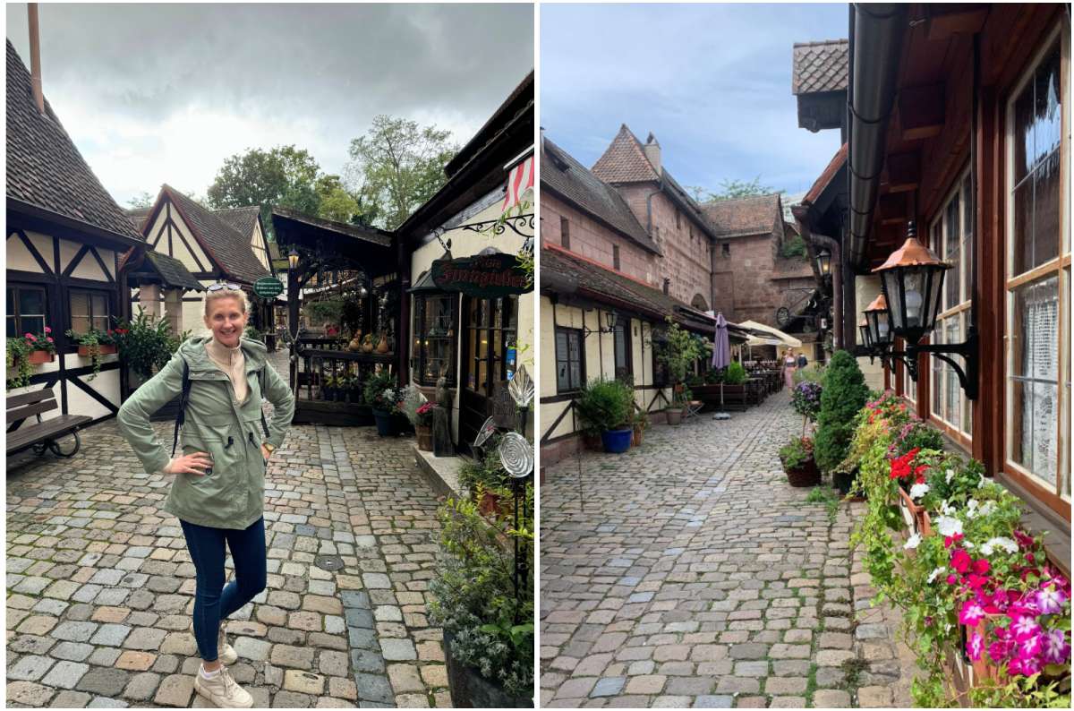 A woman smiling in the charming cobbled alley of Handwerkerhof  while visiting Nuremberg, photo by Next Level of Travel