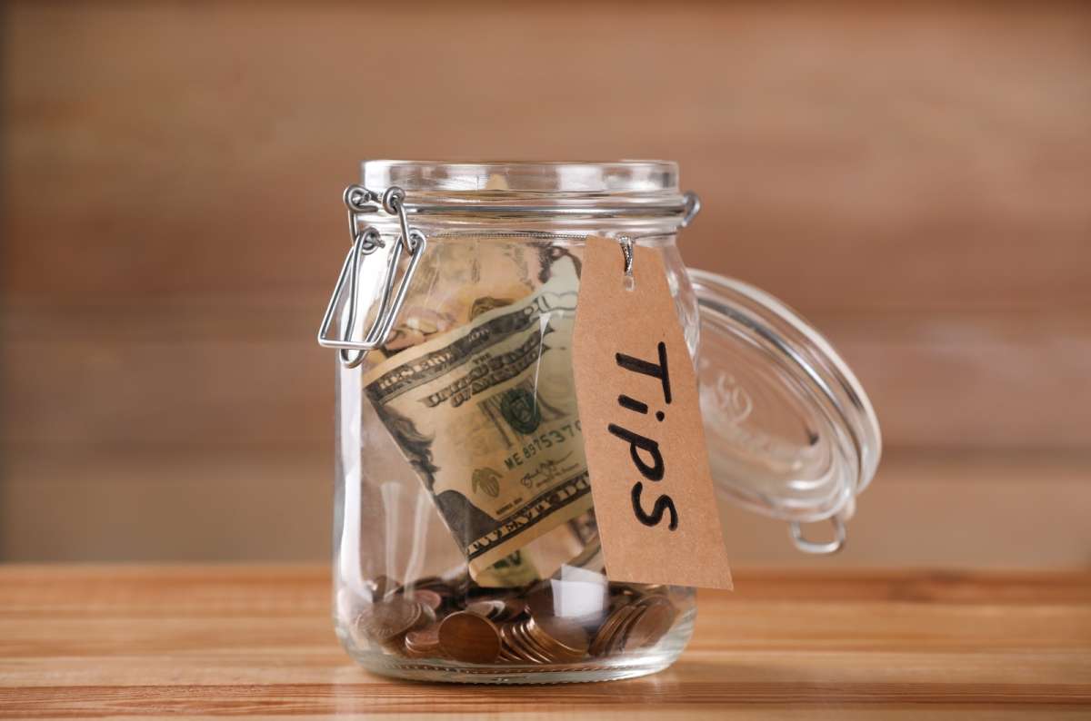 a photo of a tip jar with some money already in it