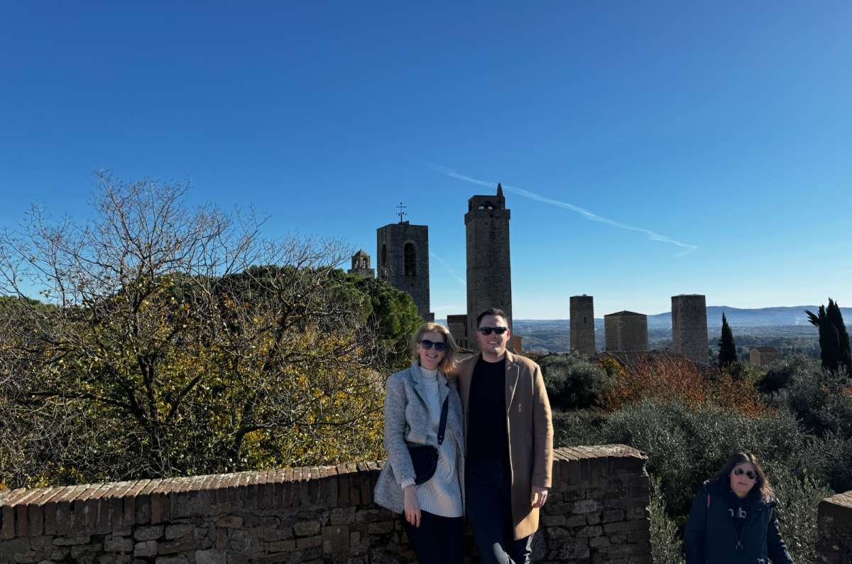 a tourist couple enjoying a sunny fall day at San Gimignano, Italy, photo by Next Level of Travel