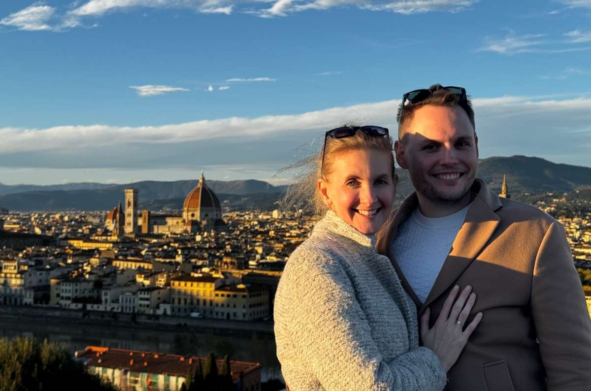 A tourist couple posing in front of the Florence scenery, Italy, photo by Next Level of Travel