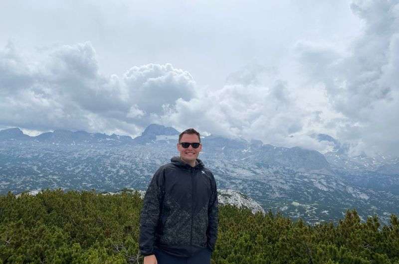 in front of a dramatic alpine backdrop at 5 Fingers in Austria, photo by Next level of travel