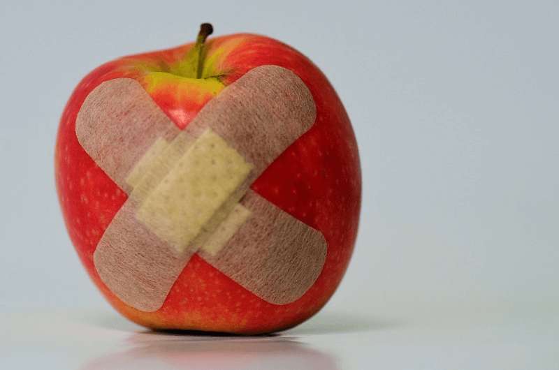 An apple with a bandage