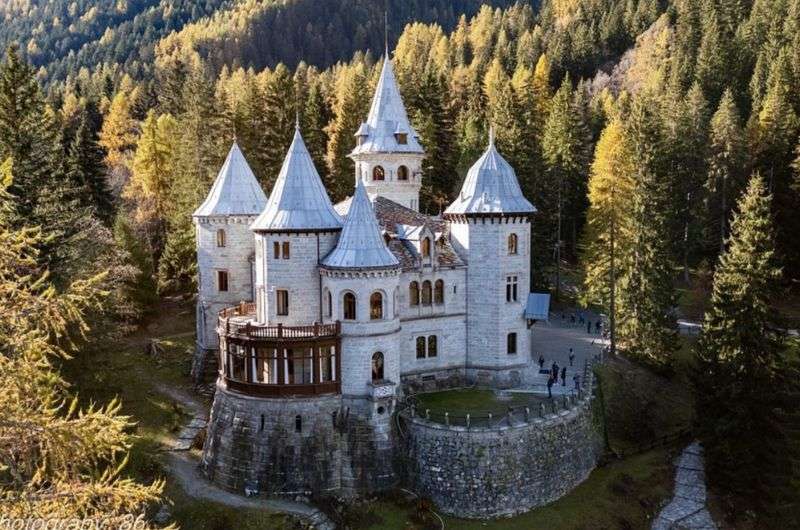 A photo of the Savoy castle and the surrounding forest, best places to see in Aosta Valley, Italy