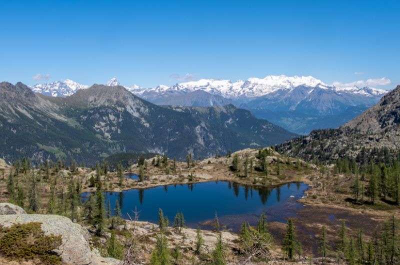 Alpine lake surrounded with panoramic mountain views in Mont Avic Natural Park, Italy