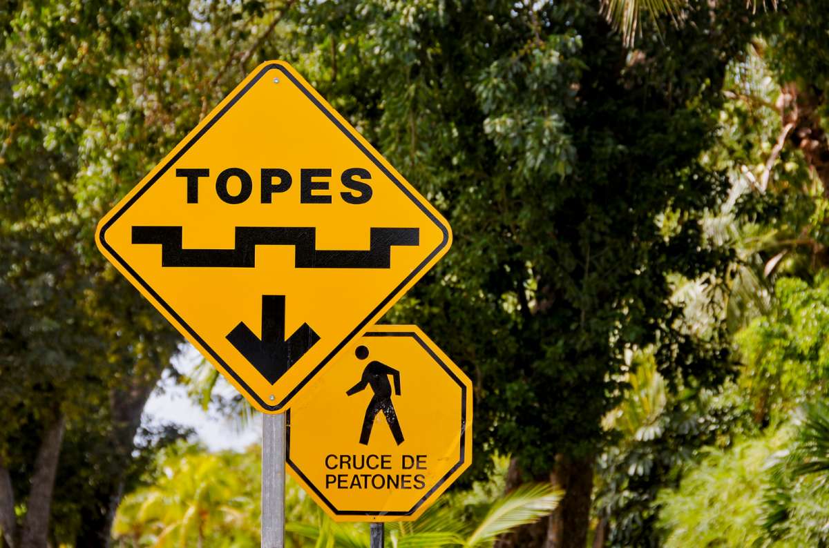 a photo of the road sighn warning the drivers about topes with another road sign in spanis in the background, Mexico