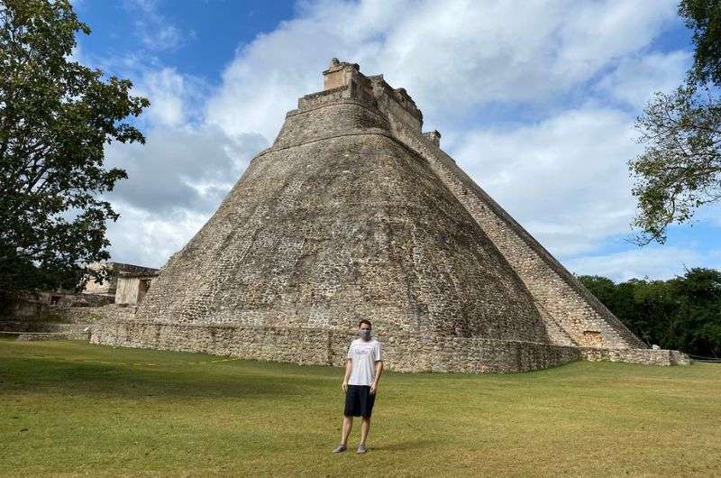 A tourist in front of a temple in Mexico