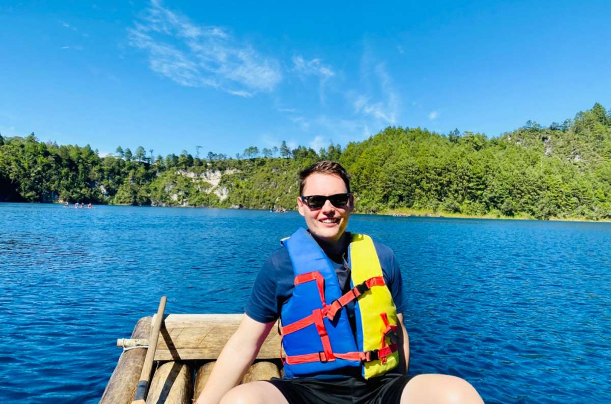 a photo of a visitor on a wooden raft wearing a life vest at Lagos de Montebello, Chiapas, Mexico, photo by Next Level of Travel
