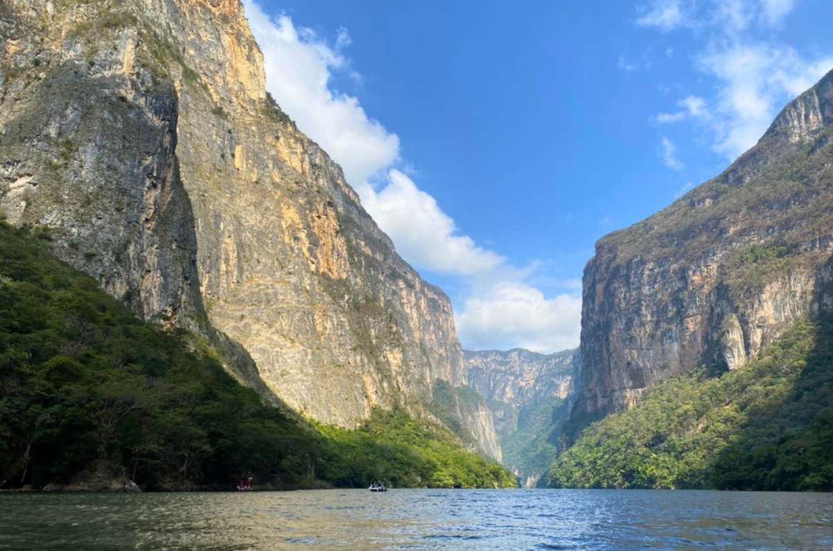 Boat cruising through Sumidero Canyon with steep cliffs and river in Chiapas, Mexico, photo by Next Level of Travel