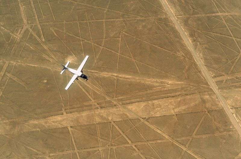 Plane flying above the Nazca Lines near Paracas, Peru
