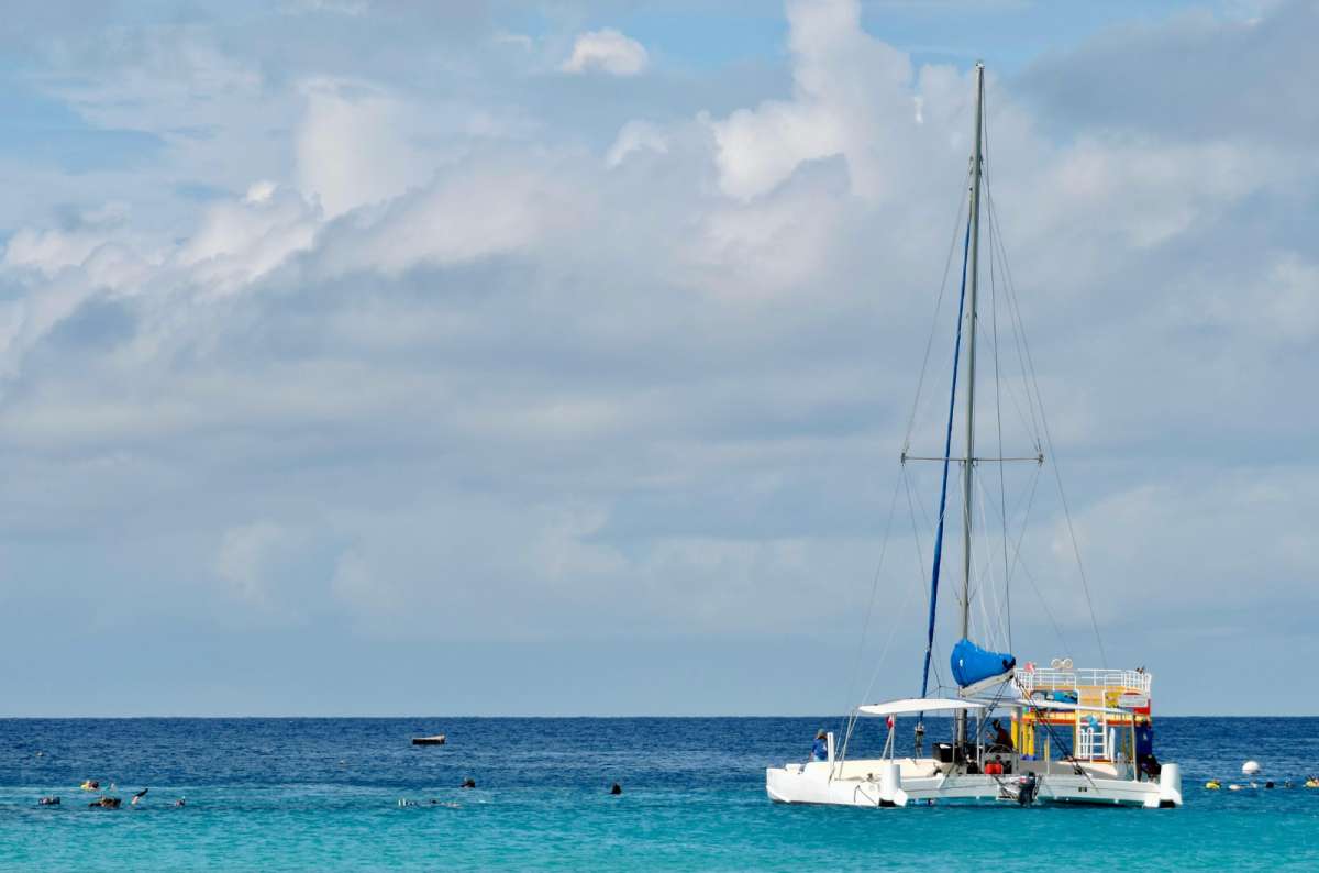 Catamaran anchored at El Cielo, Cozumel Island, Mexico, with turquoise water and snorkelers in the Caribbean Sea 