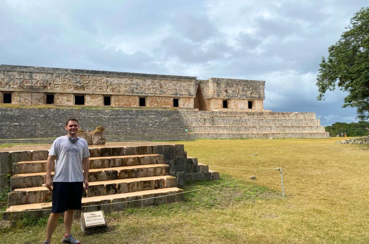 Visitor standing in front of ancient Mayan ruins in Uxmal archaeological site, Yucatán, Mexico, one of the best places to visit in Yucatan, photo by Next Level of Travel