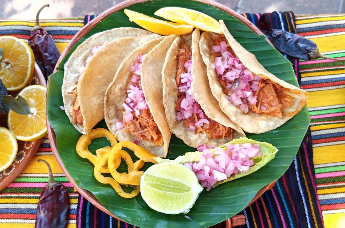 a photo of Cochinita Pibil, a traditional Mexican food made of pork and banana leaves, Mexico