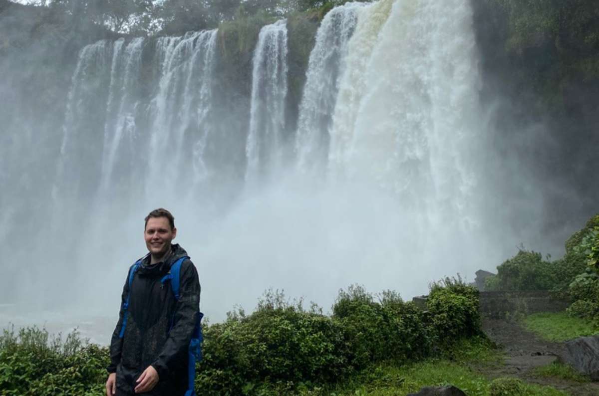 a tourist posing in front of massive waterfalls at Veracruz, Mexico, photo by Next Level of Travel