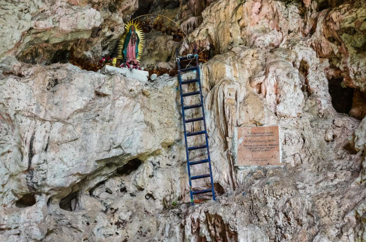 a close-up photo of the Cave of Color in the Sumidero Canyon, showing the religious decorations in the cave, Chiapas, Mexico