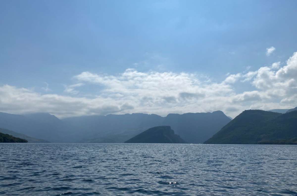 a photo of the Sumidero Canyon showing the bluew water and smaller rock formations visible in the background, Mexico, photo by Next Level of Travel