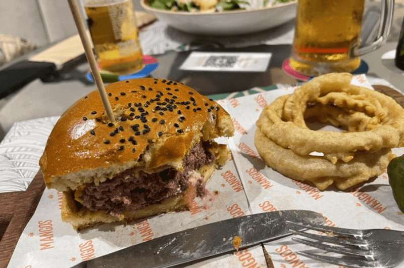 Half-eaten hamburger at Mangos Restaurant, top restaurant in Lima Peru