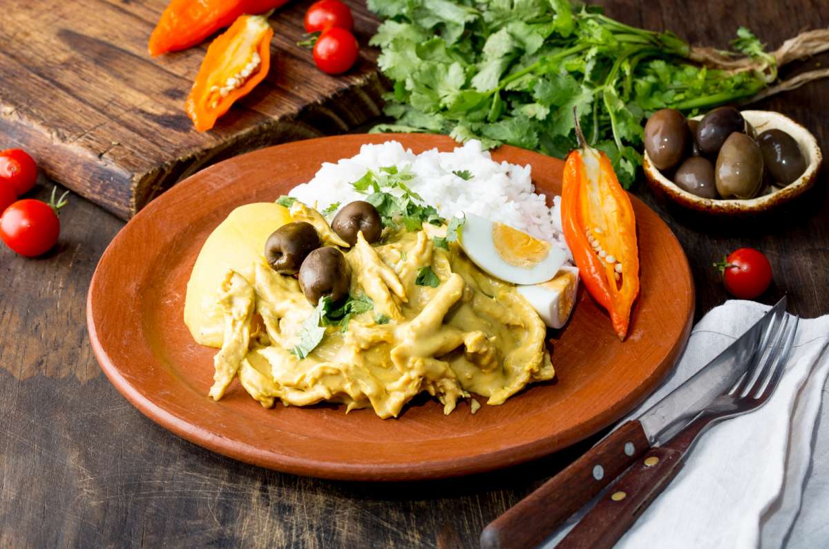 a photo of Ají de gallina, a traditional Peruvian meal, served with hard boiled eggs on the side, Peru, photo by Next Level of Travel