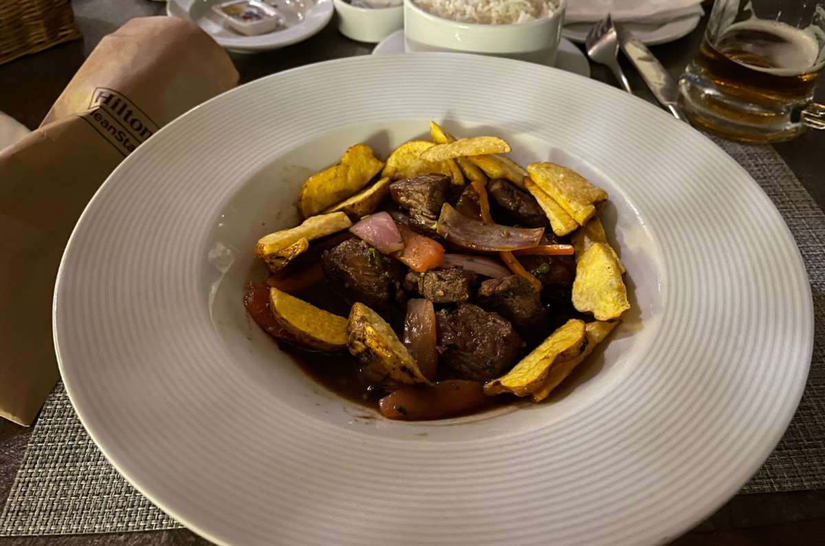 a photo of lomo saltado, a traditional peruvian meal, made of beef, potatoes and rice, Peru, photo by Next Level of Travel