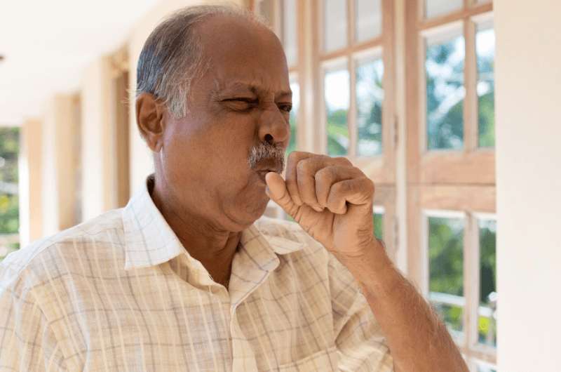 A man coughing