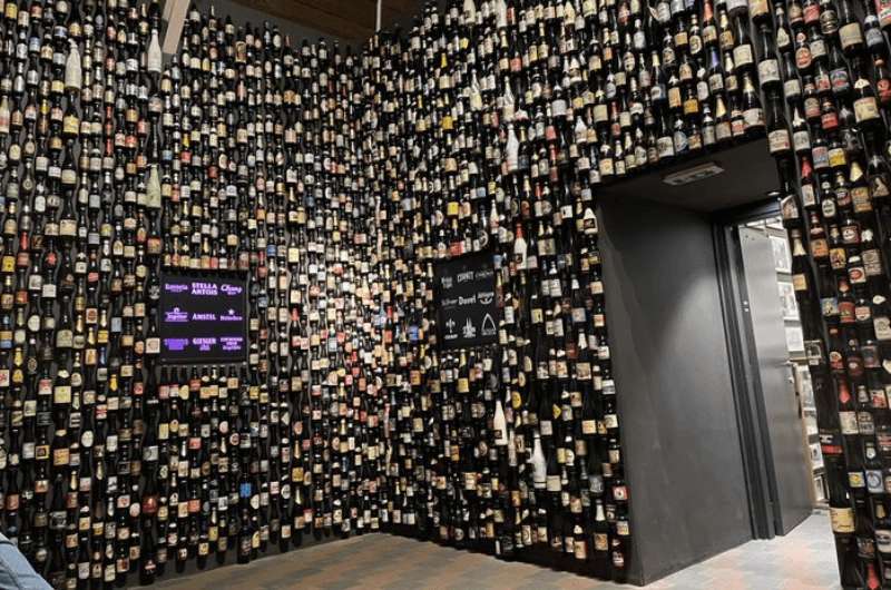 One of the rooms with beer bottles on the walls at the Beer Experience in Bruges, Belgium