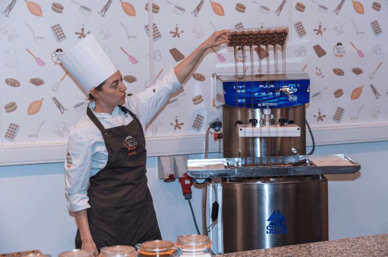 Woman demonstrating chocolate production in Choco Story Museum in Bruges