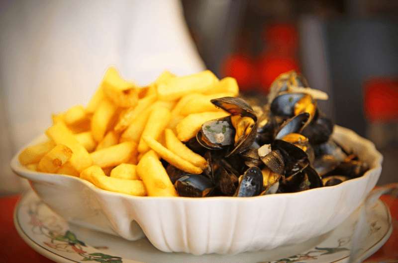 A dish of mussels and fries, the Belgian food called  moules frites