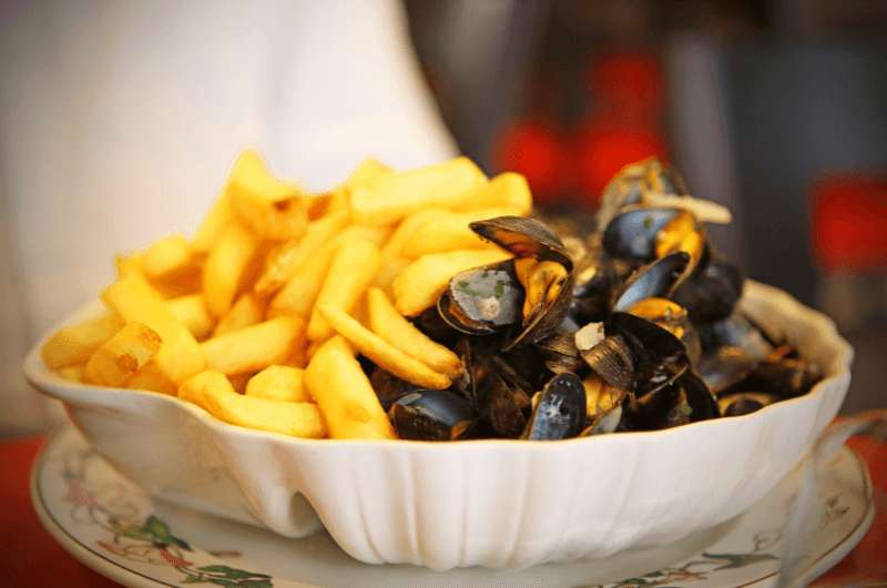 A dish of mussels and fries, the Belgian food called  moules frites
