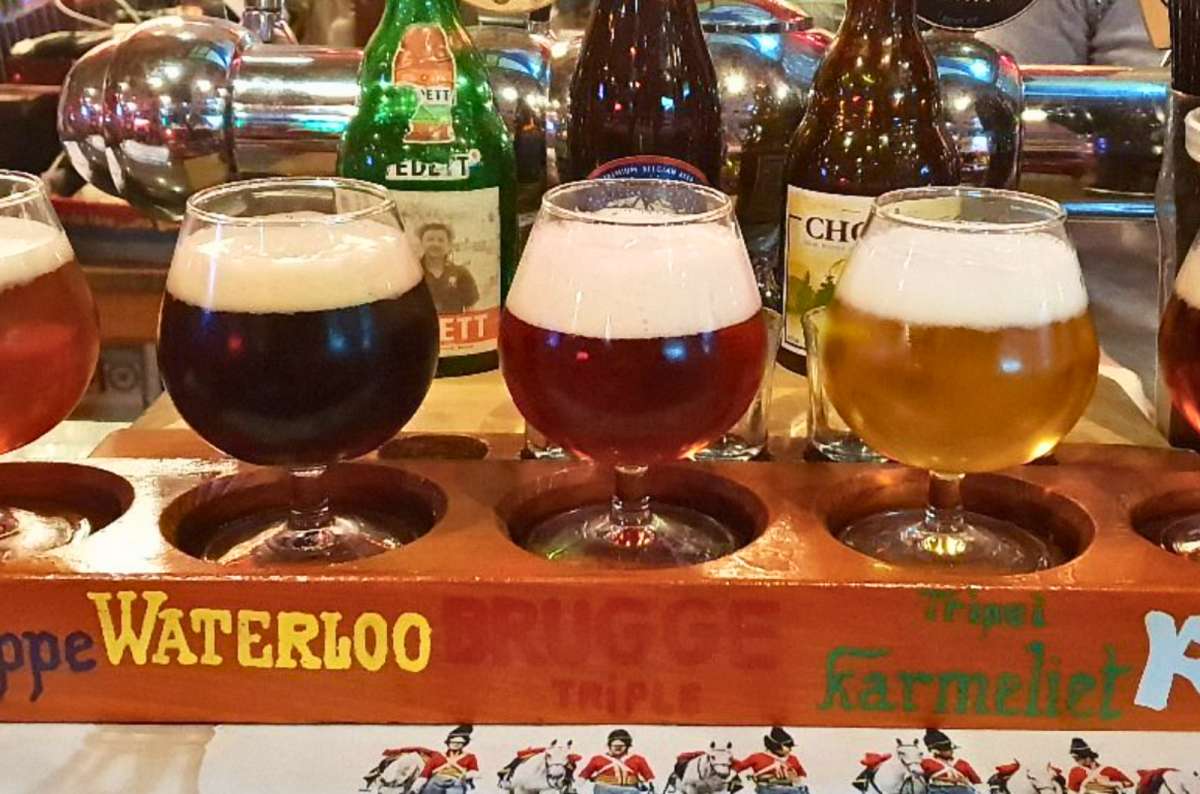 Selection of Belgian craft beers in tasting glasses at Au Brasseur bar in Brussels