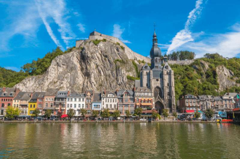 Dinant town with colorful houses, church and citadel by the Meuse River in Belgium