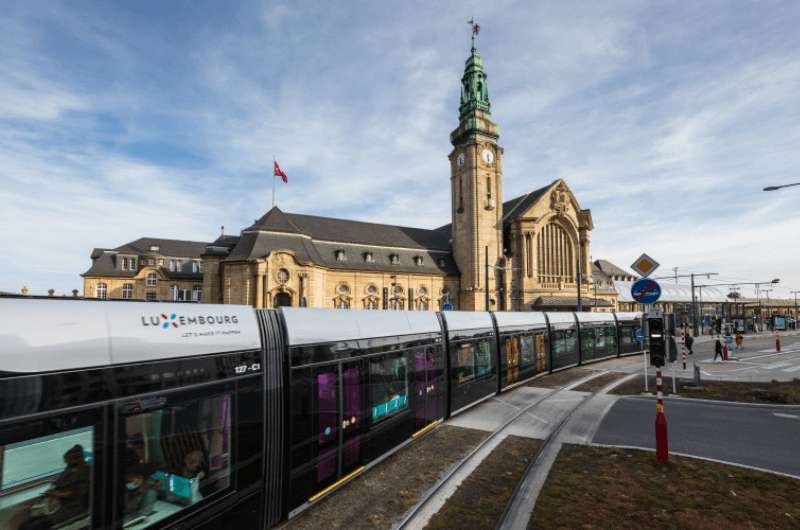 The main train station in Luxembourg city with a tram in the forefront