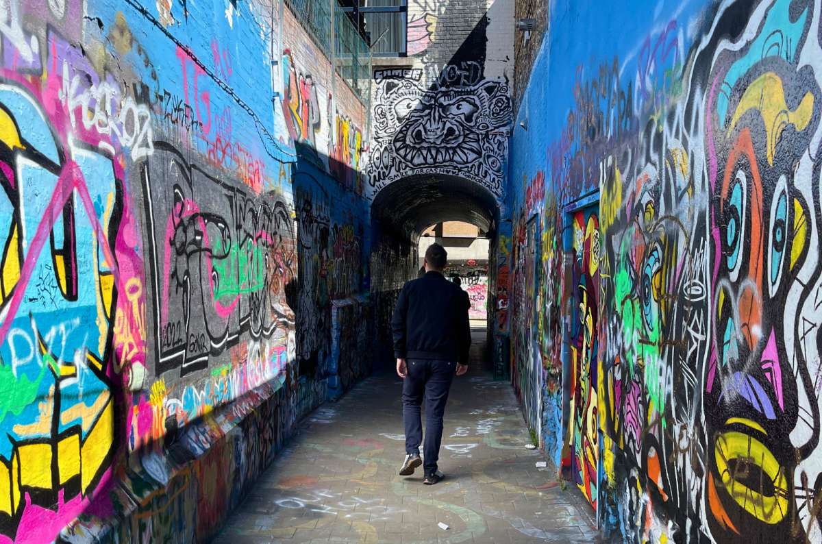 A tourist walking through the Werregarenstraatje, Ghent, Belgium, photo by Next Level of Travel