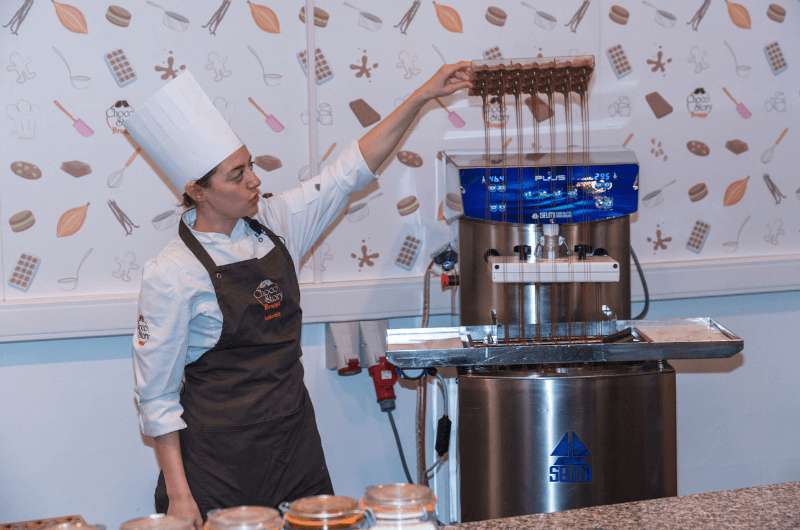 Woman demonstrating chocolate production in Choco Story Museum in Bruges 