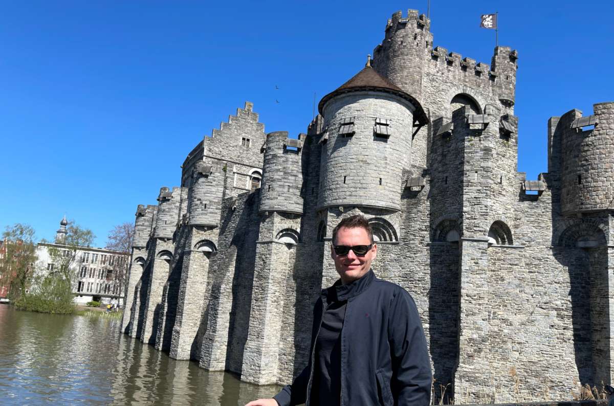 a tourist posing in front of the Castle of Counts, Ghent, Belgium, photo by Next Level of Travel