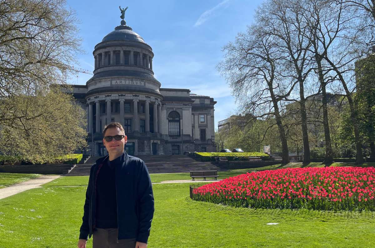 a photo of a tourist posing in front of the Museum of Art and History, Brussels, Belgium, photo by Next Level of Travel