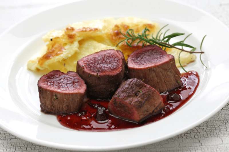 Venison steak on a plate with mashed poatoes