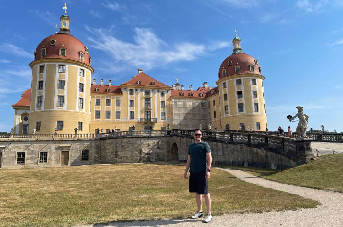 Man stands in front of Moritzburg Castle near Dresden, Germany, photo by Next Level od Travel