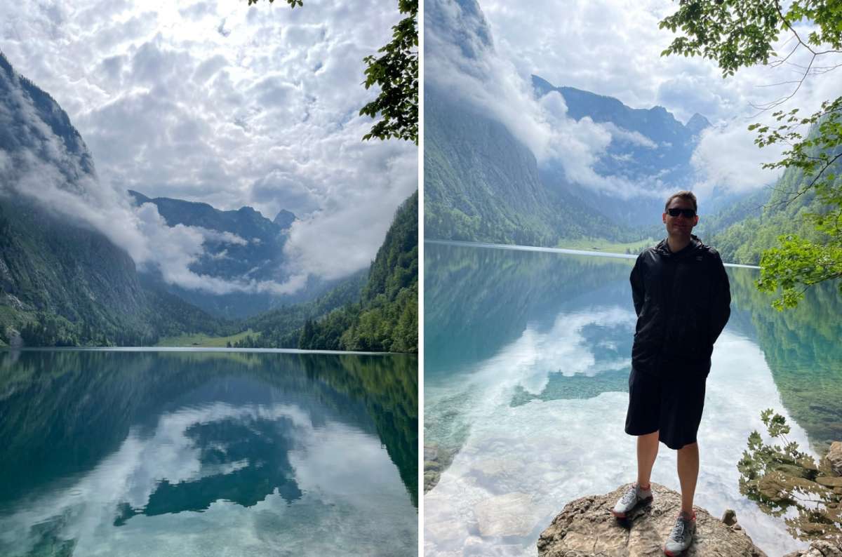 A tourist posing in front of lake Königsee with the mountain view visible in the background, photo by Next Level of Travel