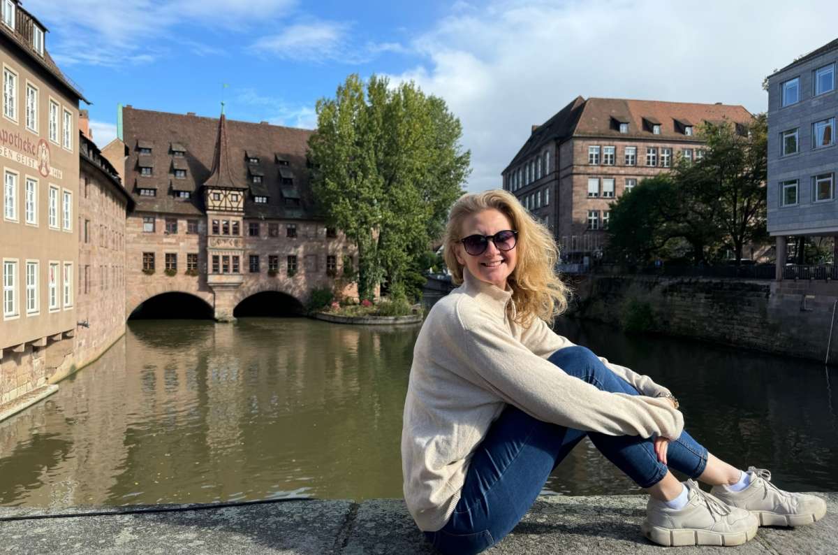 A woman posing in front of the Heilig Geist Haus, photo by Next Level of Travel