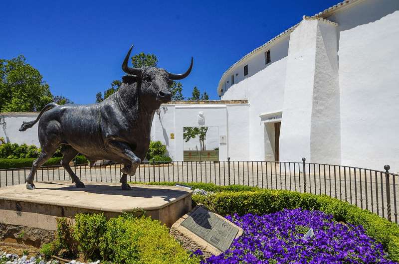 Bull statue in front of bullfighting arena in Ronda, Spain