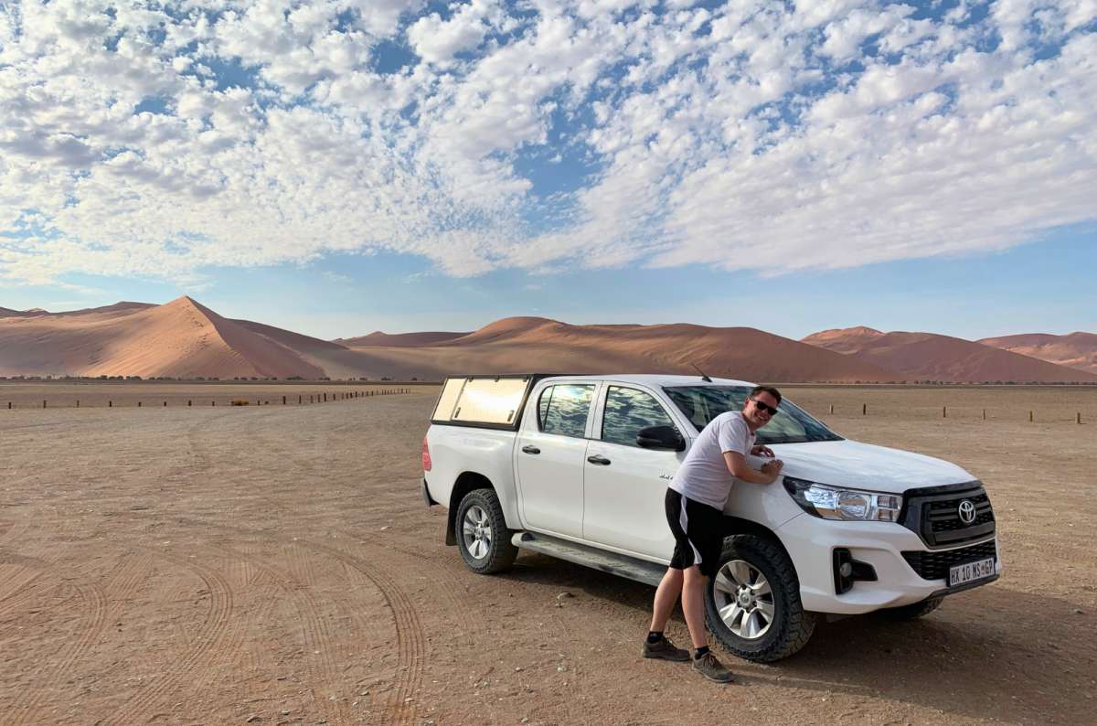 Tourist with rental car in Namib Desert near Sossusvlei, Namibia, photo by Next Level of Travel