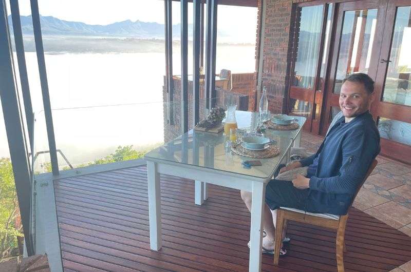Man sitting at a private dining table on the hotel balcony, Kambaku @ Sea Hotel, Garden Route, photo by Next level of travel 