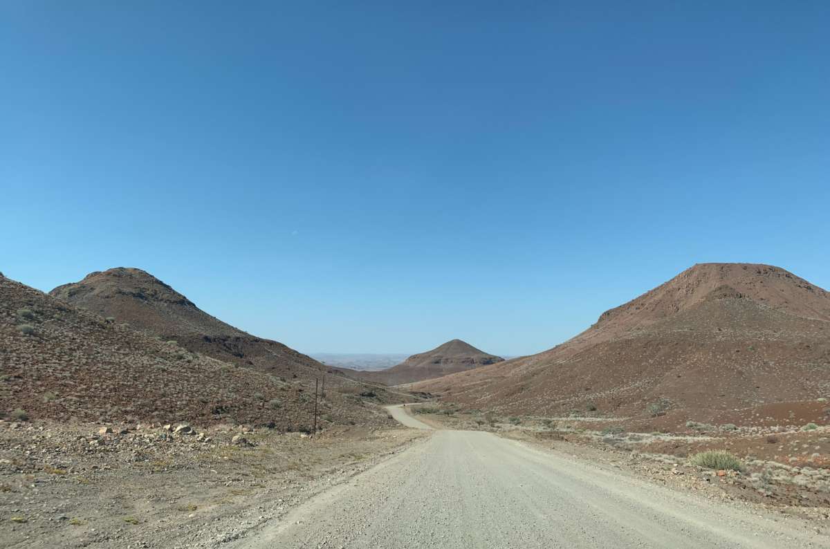 Gravel road through rocky desert landscape in Damaraland, Namibia, photo by Next Level of Travel