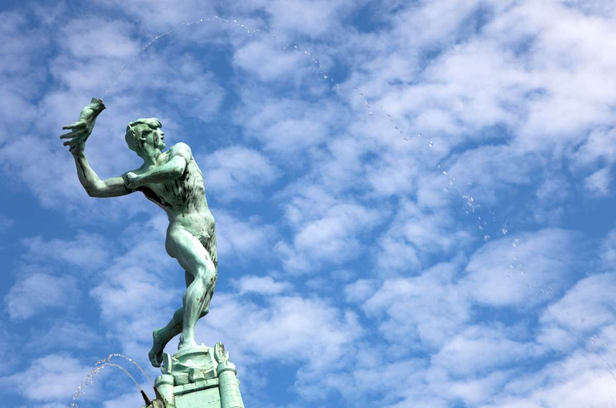 a close-up photo of the statue of Brabo throwing a hand at Grote Markt, Antwerp, Belgium