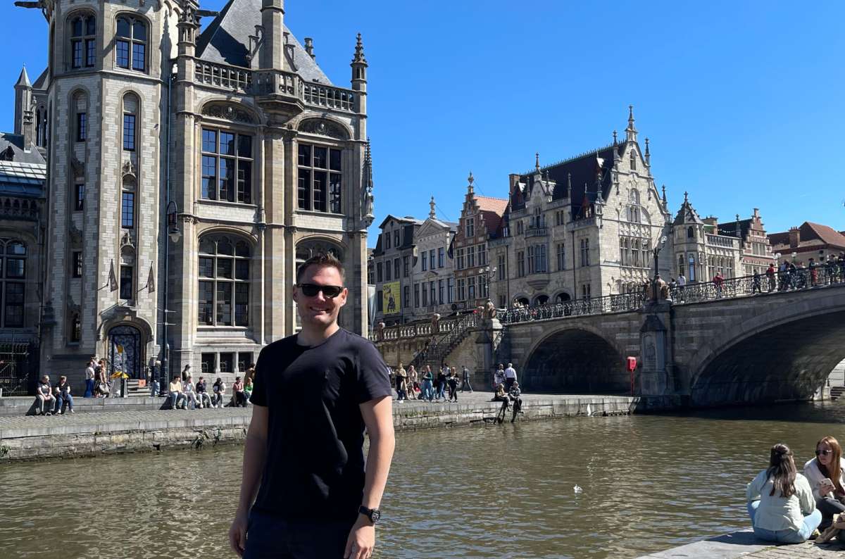 A photo of a tourist posing in front of St. Michale’s Bridge, Ghent, photo by Next Level of Travel