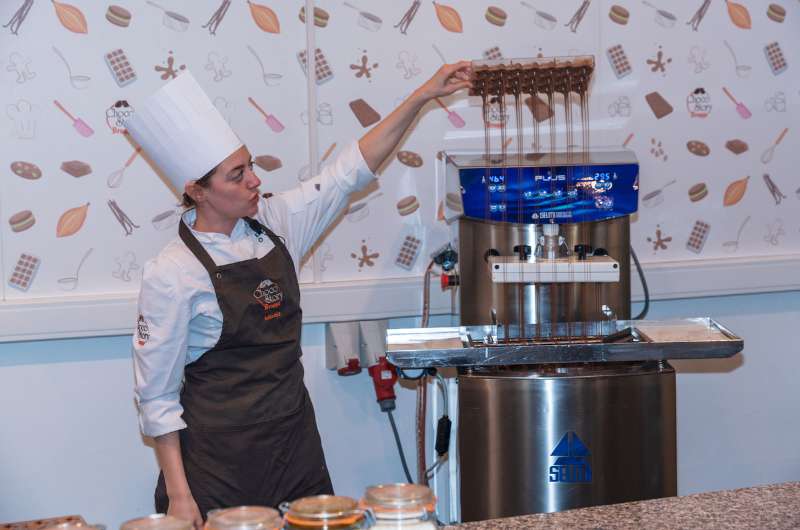 Woman demonstrating chocolate production in Choco Story Museum in Bruges