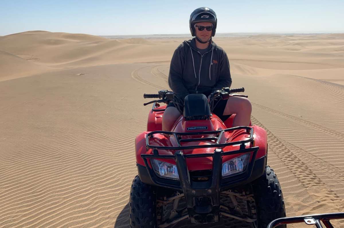 a photo of a tourist quad biking on the sand dunes near Swakopmund in Namibia, photo by Next Level of Travel