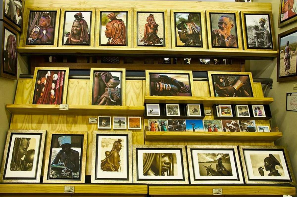 a photo of framed portraits and artwork of Namibian indigenous people on display at the Namibia Craft Centre in Windhoek, photo by Next Level of Trave